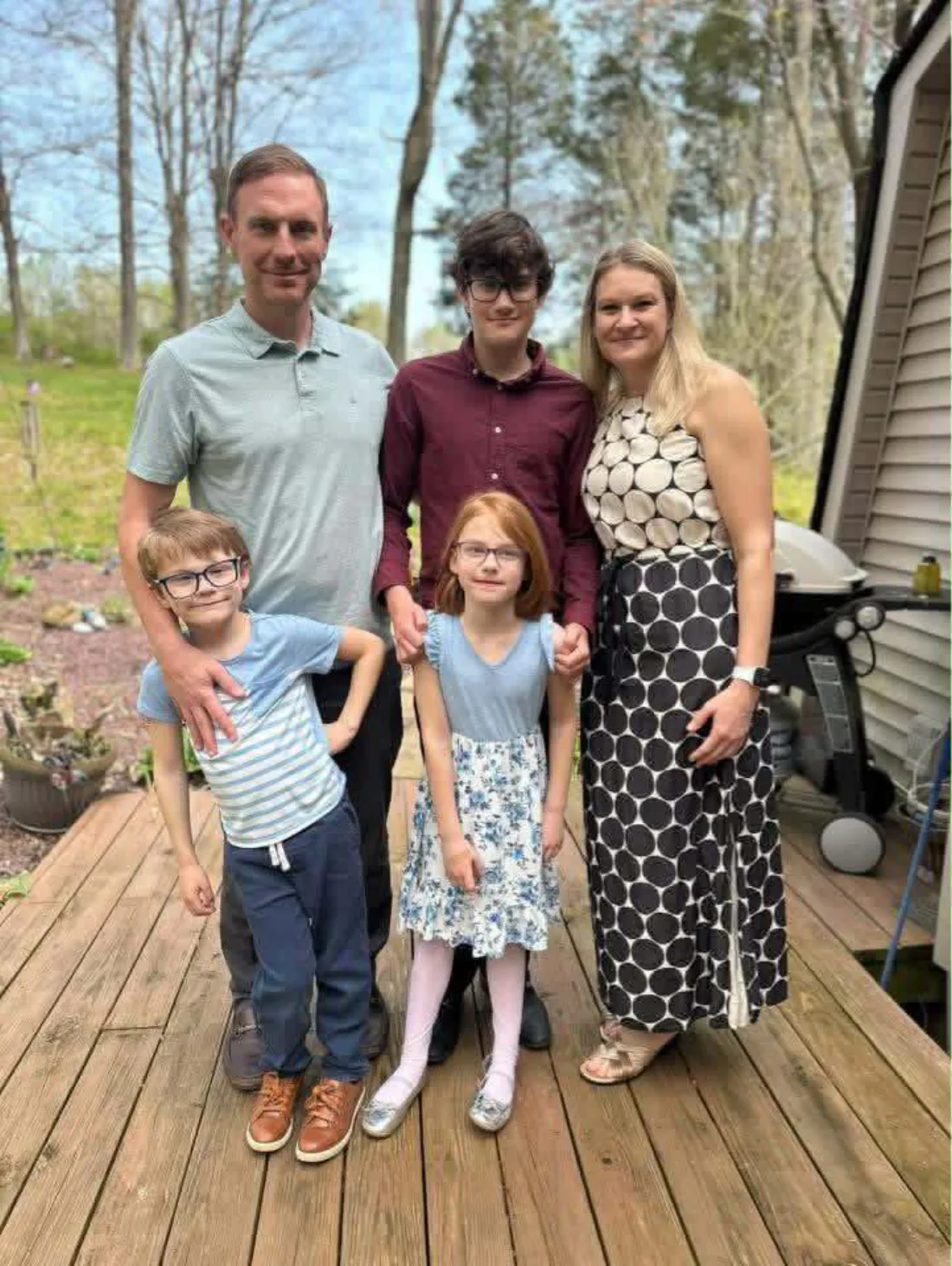 Sarah with her husband Chris and their three children on the back deck