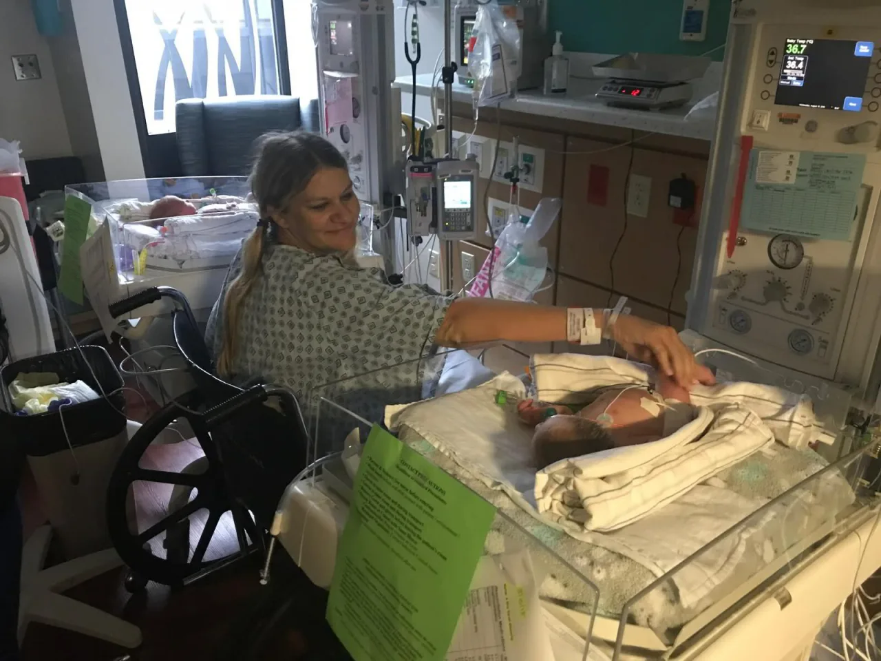 A parent and newborn in a neonatal care unit — rural Hoosiers need access to local hospitals