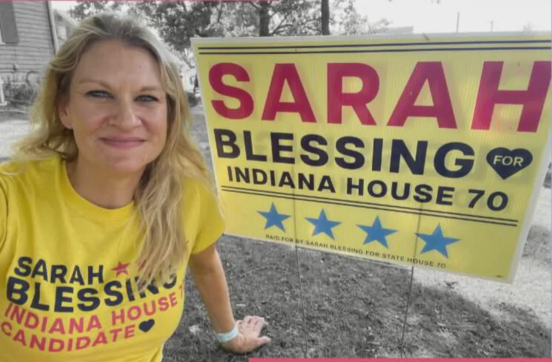 Sarah with her campaign yard sign